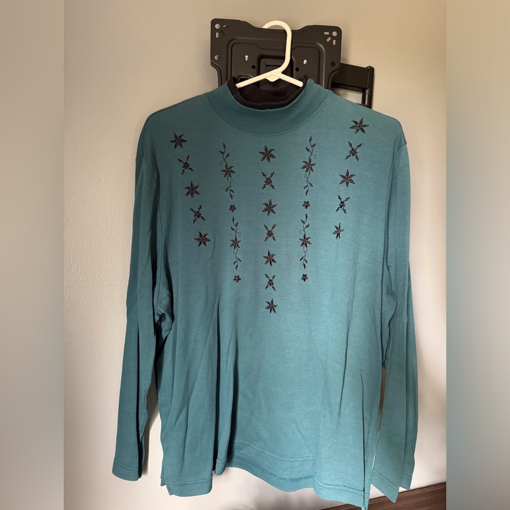 Women’s size large, long sleeve greenish blue top with black embroidery detail